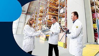 Two people in the warehouse hand over the parts and one person with checklist in hand