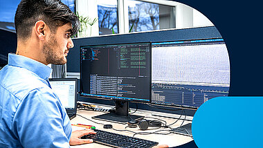 A man sits in front of a PC screen