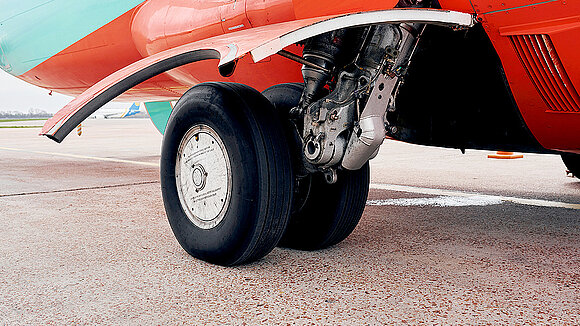 Close-up of an aircraft flap and a tire