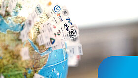 Cut of a globe with many small flags