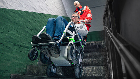 The Upstair transport aid in use with a patient on a staircase