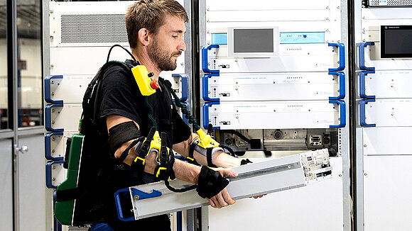 A man wearing an exoskeleton while lifting