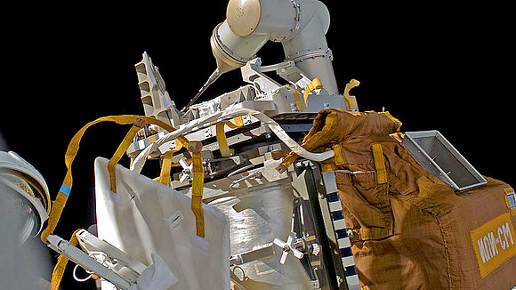 Close-up of a robotic arm in space exploration