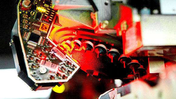 Component in production on which red light shines