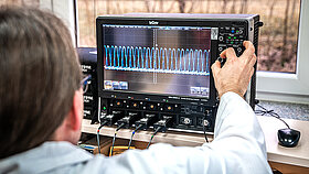 A person checks values on a measuring device