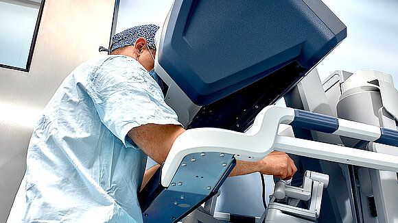 A doctor at a surgical robot monitor