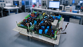One hand holds small components