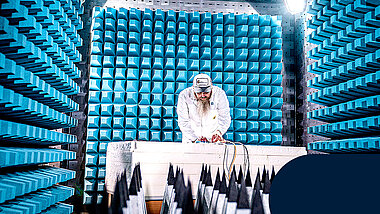 An employee is testing something in the EMC testing room