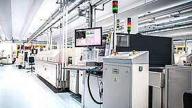 View of an aisle in a production facility with production equipment