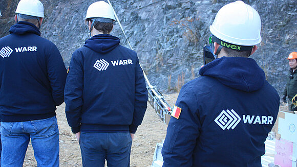 Drei WARR Mitarbeiter in Rückenansicht