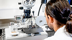 An employee is testing something during a wear test