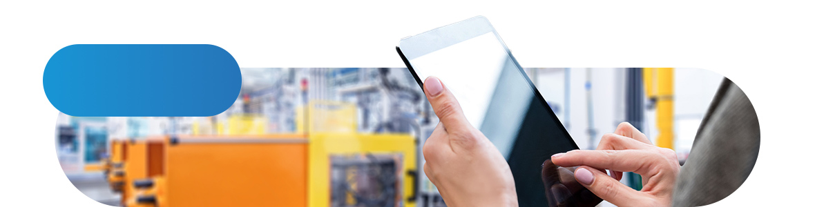 Hands holding a black tablet in the background production facilities