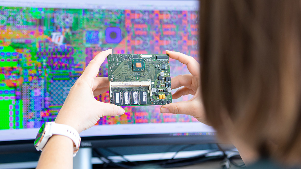 Embedded module in the hands in front of a PC