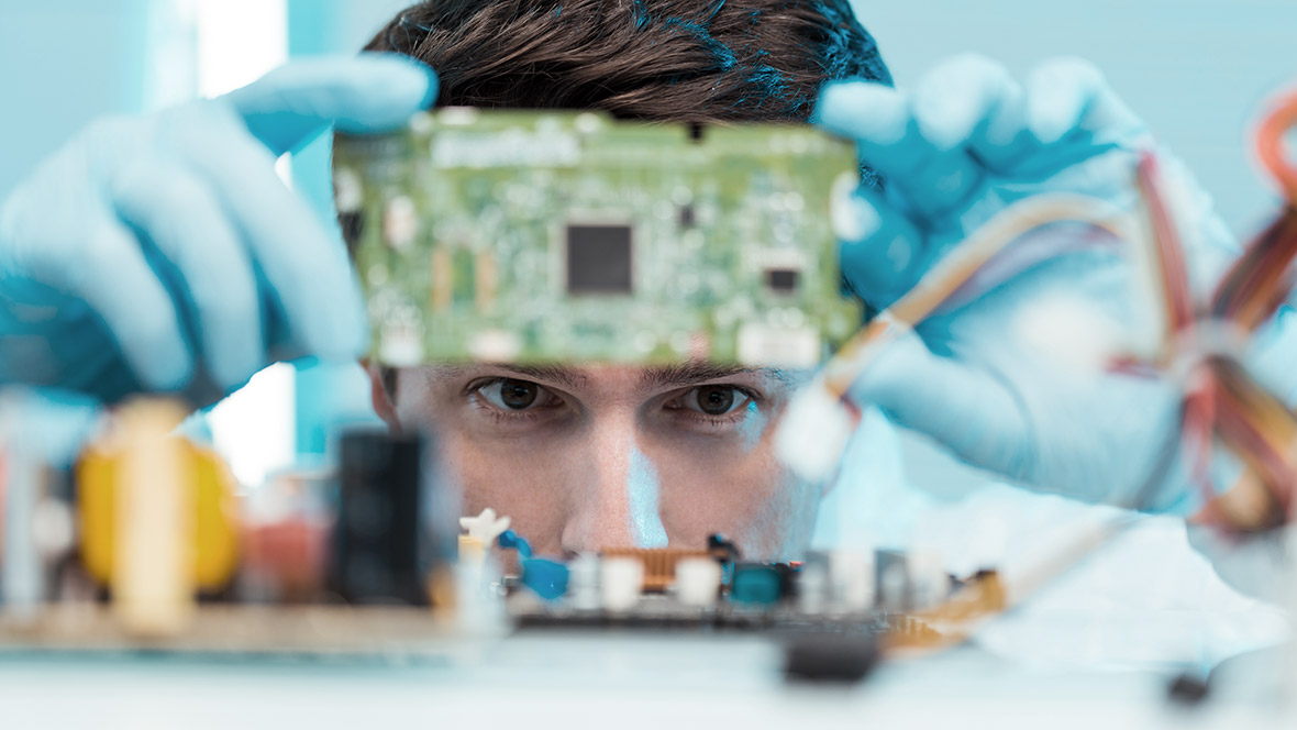 Man with blue gloves and module